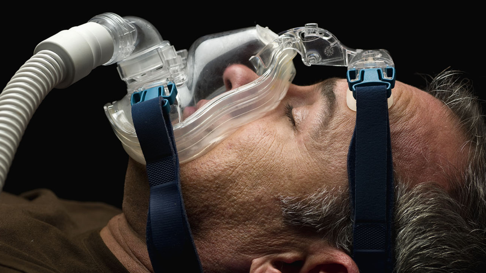 mature man sleeping, using a mask for sleep disorder treatment (this picture has been taken with a Hasselblad H3D II 31 megapixels camera)