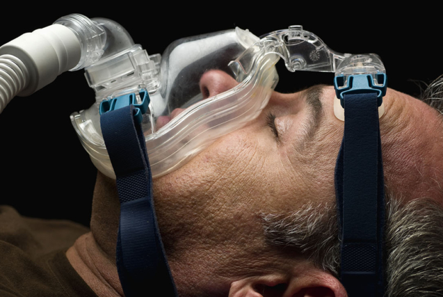 mature man sleeping, using a mask for sleep disorder treatment (this picture has been taken with a Hasselblad H3D II 31 megapixels camera)